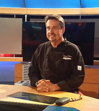 Chef Ray Martin seated in a professional kitchen